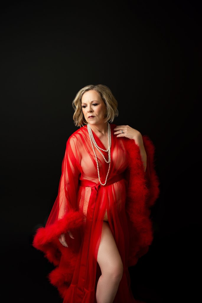 A boudoir portraits of an older woman with wearing a red robe
